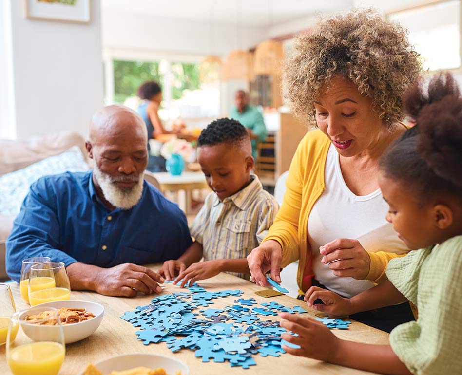 grandparents doing a puzzle with their grandkids while eating breakfast retirement future